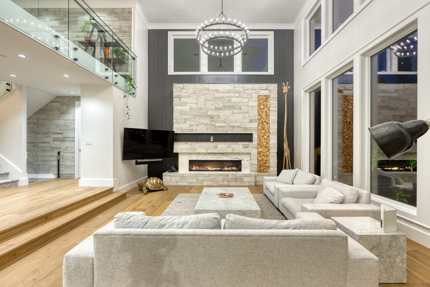 Custom living room with large couches and chandelier by Midland Premium Properties in the Greater Vancouver area. 